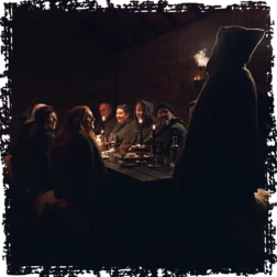 Guests sit together at a wooden table listening Viking stories