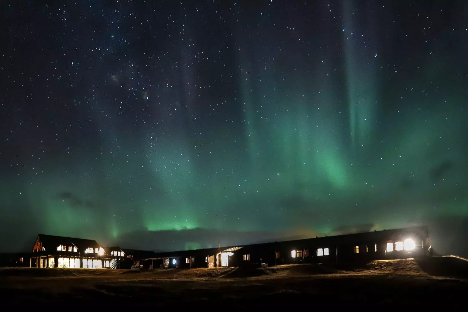 Hella hotel in Iceland beneath northern lights