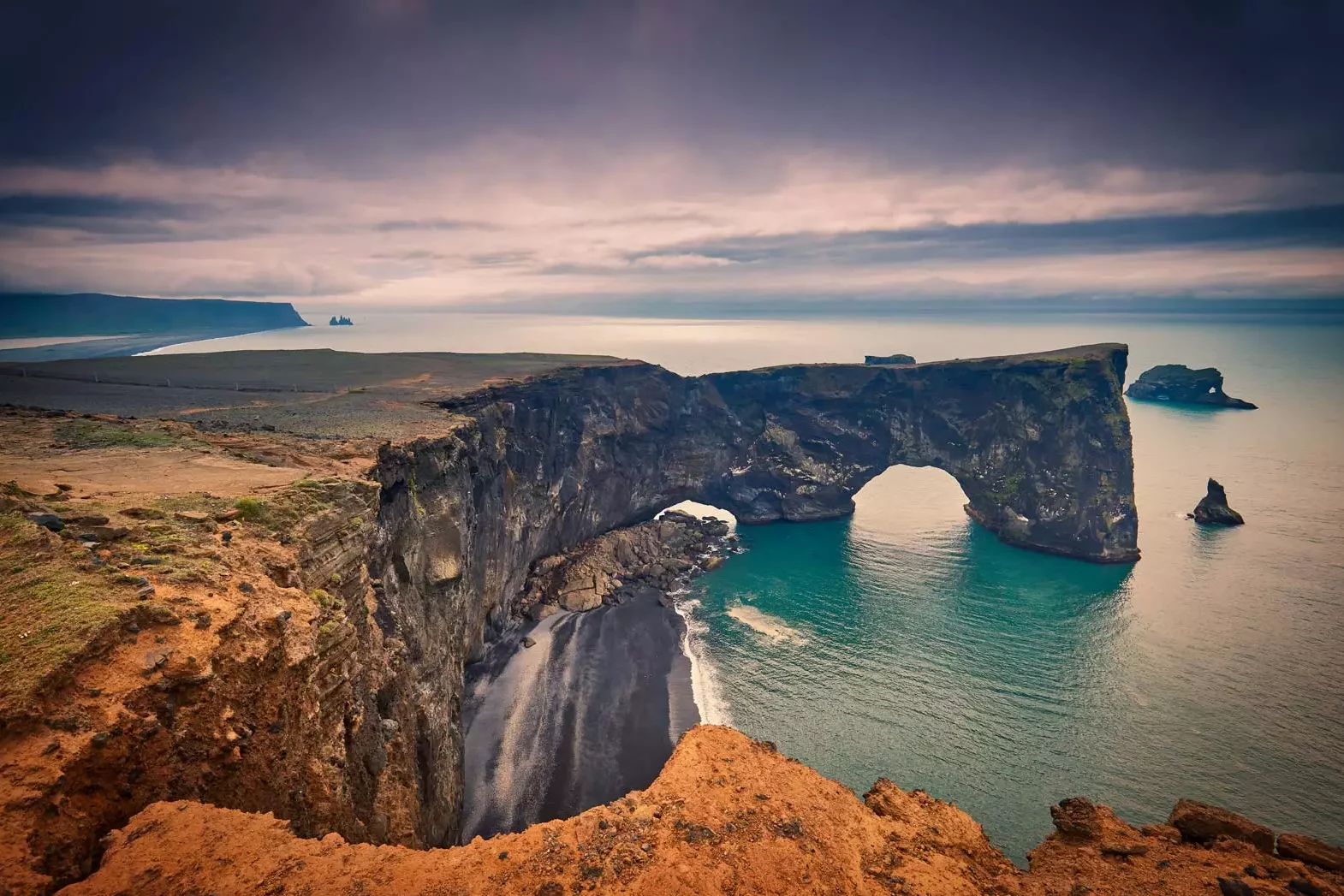 Landscape with basalt rocky cape and ocean - peninsula Dyrholaey Reynisdrangar Vik