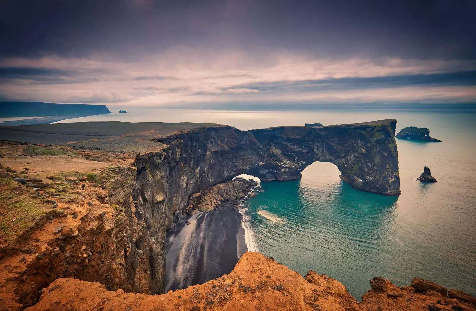 Landscape with basalt rocky cape and ocean - peninsula Dyrholaey Reynisdrangar Vik