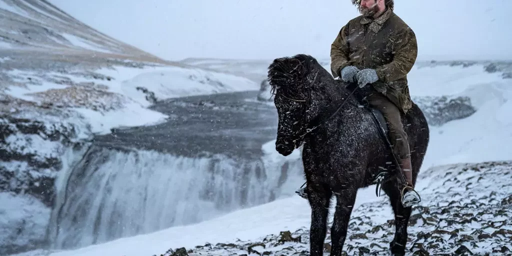 Mr Iceland - Hordur Bender with his horse near waterfall in winter