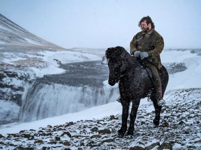 Mr Iceland - Hordur Bender with his horse near waterfall in winter