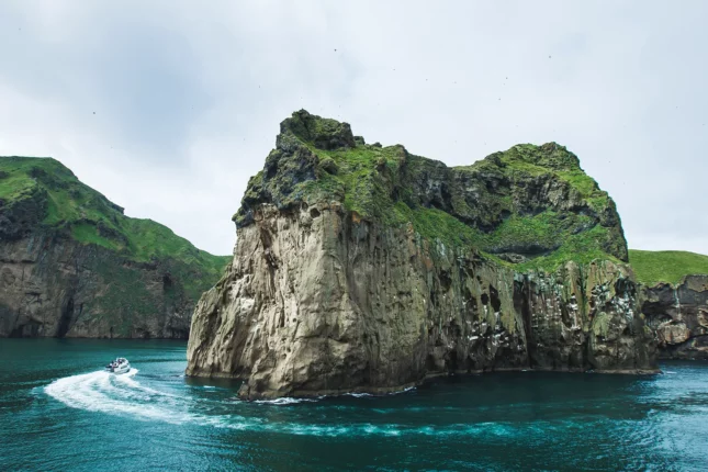 Rocky coast of Vestmannaeyjar island in Iceland by boat in adventure trip