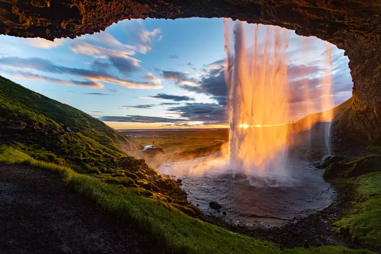 Seljalandsfoss waterfall cave at sunset in summer